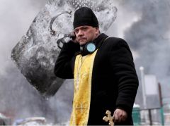 priest walks with A cross And shield